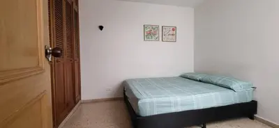 a bedroom with a bed in a white room at 1023 Los Colores Estadio apartamento - Parqueadero - Zona Wifi - Coworking - Área exclusiva de la ciudad in Medellín