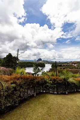 a view of a river from a garden at Finca-Hotel Montecarlo Guatape by Hope in Guatapé