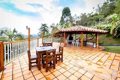 a deck with a gazebo and a table and chairs at Finca-Hotel Montecarlo Guatape by Hope in Guatapé