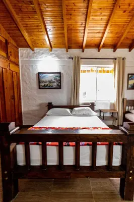 a bedroom with a large bed in a room at Finca-Hotel Montecarlo Guatape by Hope in Guatapé