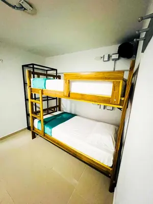 a room with two bunk beds in a room at Kromatic Hostel in Medellín