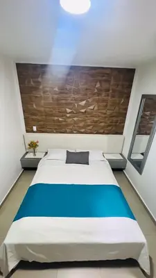 a bedroom with a large bed in a room at Kromatic Hostel in Medellín