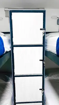 a pair of bunk beds with a door in a room at Kromatic Hostel in Medellín