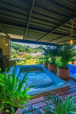 a swimming pool in a backyard with plants at Hotel Bambu Guatape in Guatapé