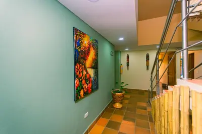 a hallway with a painting hanging on a wall at Hotel Bambu Guatape in Guatapé