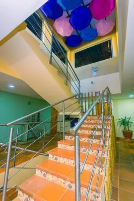 a set of stairs with a colorful ceiling at Hotel Bambu Guatape in Guatapé