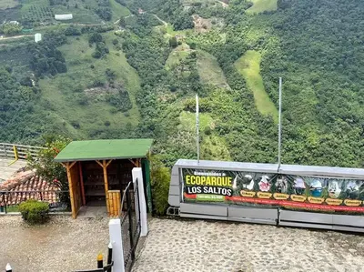 a building with a sign on it next to a mountain at New Lovely 3 bedroom condo with an AWESOME view! in Bello