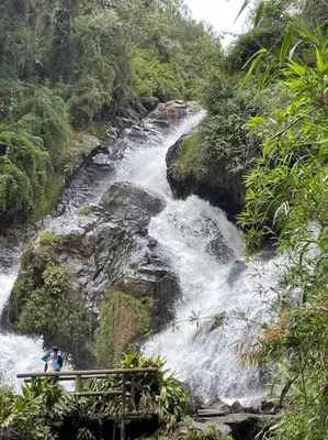 a person on a bridge over a waterfall at New Lovely 3 bedroom condo with an AWESOME view! in Bello