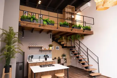 a loft office with a staircase with potted plants at Royal Living Poblado in Medellín