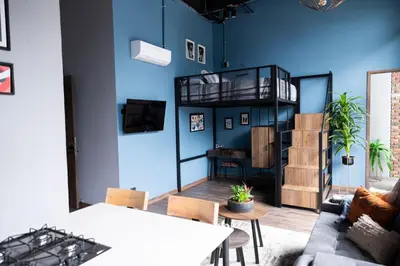 a living room with a blue wall at Royal Living Poblado in Medellín