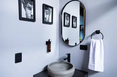 a bathroom with a sink and a mirror at Royal Living Poblado in Medellín
