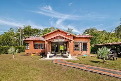 a small brick house in a field of grass at Moderna cabaña en Viterbo con Aire AC y Piscina in Viterbo