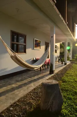 a hammock outside of a building with a room at Encanto! Casa de campo en Café de la Cima in Fredonia