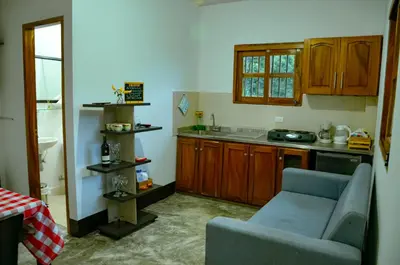 a living room with a couch and a kitchen at Encanto! Casa de campo en Café de la Cima in Fredonia