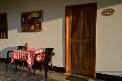 a table with a red and white checkered table cloth and a door at Encanto! Casa de campo en Café de la Cima in Fredonia