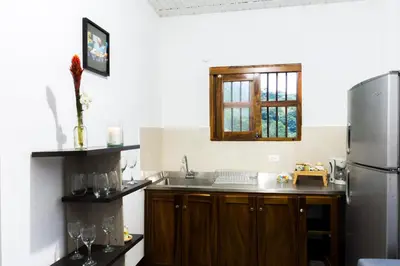 a kitchen with a sink and a refrigerator at Encanto! Casa de campo en Café de la Cima in Fredonia