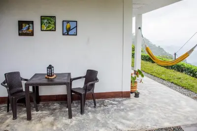 a table and chairs on a patio with a view at Encanto! Casa de campo en Café de la Cima in Fredonia