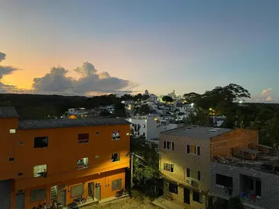 a view of a city at sunset with buildings at Hotel SG in Doradal