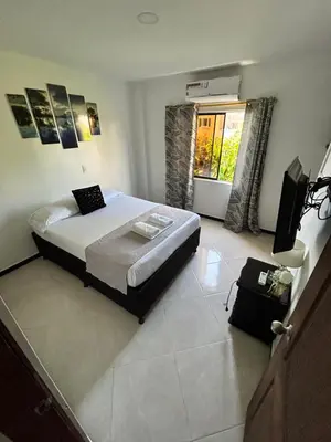 a bedroom with a bed and a television in it at Hotel SG in Doradal