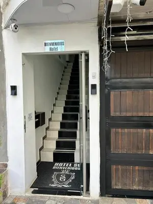 a door to a building with a staircase next to it at Hotel SG in Doradal