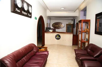 a living room with leather couches and a bar at Ayenda 1133 Casa Polty in Manizales