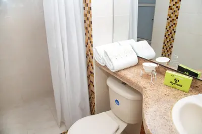 a bathroom with a toilet and a sink and a mirror at Ayenda 1133 Casa Polty in Manizales