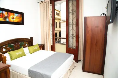 a bedroom with a bed and a door to a balcony at Ayenda 1133 Casa Polty in Manizales