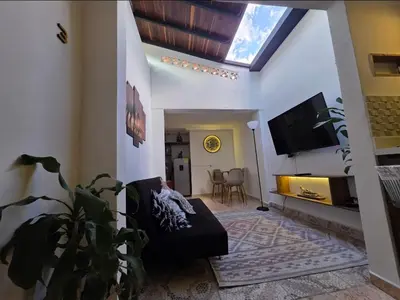 a living room with a couch and a flat screen tv at alojamiento entero a 800metros estación poblado in Medellín