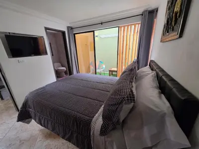 a bedroom with a bed with a large window at alojamiento entero a 800metros estación poblado in Medellín