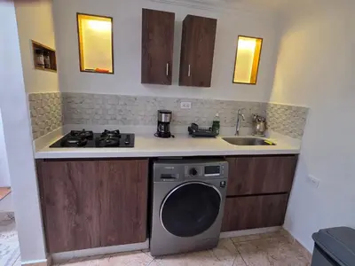 a kitchen with a washing machine and a sink at alojamiento entero a 800metros estación poblado in Medellín