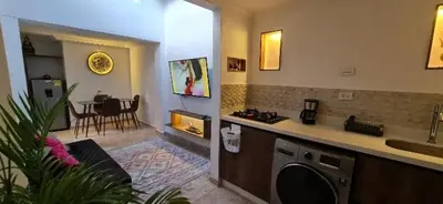 a kitchen and living room with a washing machine at alojamiento entero a 800metros estación poblado in Medellín