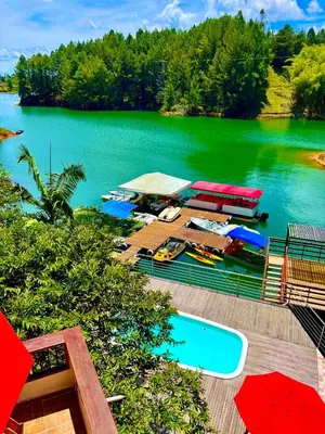 an aerial view of a lake with a boat in it at Finca Santa Monica Guatape in Guatapé