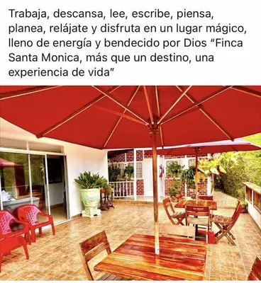 a red umbrella sitting on top of a patio at Finca Santa Monica Guatape in Guatapé