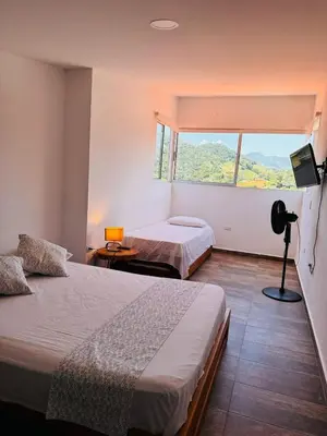 a hotel room with two beds and a window at Lagom Apartamentos San Rafael in San Rafael
