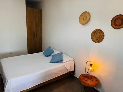 a bedroom with a bed with blue pillows and a lamp at Lagom Apartamentos San Rafael in San Rafael