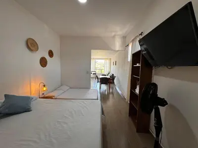 a bedroom with two beds and a flat screen tv at Lagom Apartamentos San Rafael in San Rafael