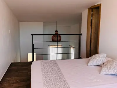a bedroom with a bed with a glass head board at Lagom Apartamentos San Rafael in San Rafael
