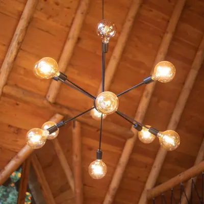 a chandelier hanging from a wooden ceiling at Cabaña con Jacuzzi en Santa Elena in Medellín