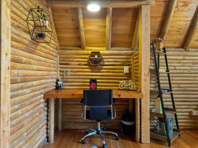 a computer desk in a room with wooden walls at Cabaña con Jacuzzi en Santa Elena in Medellín