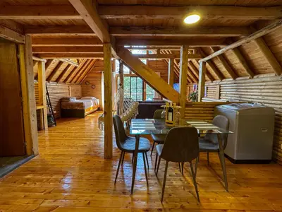 a dining room with a table and chairs at Cabaña con Jacuzzi en Santa Elena in Medellín