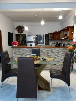 a kitchen with a table and some chairs and a counter at casa amoblada, Doradal Antioquia, Santorini colombiano in Doradal