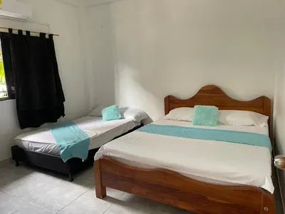 a bedroom with two beds and a window at casa amoblada, Doradal Antioquia, Santorini colombiano in Doradal