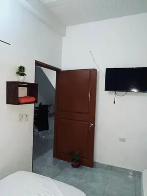 a room with a door and a television on a wall at casa amoblada, Doradal Antioquia, Santorini colombiano in Doradal