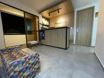 a living room with a couch and a lobby at Hotel Medallo City in Medellín