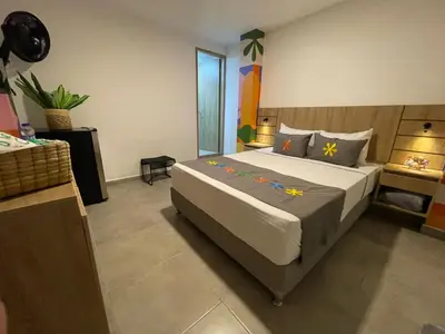 a bedroom with a large bed in a room at Hotel Medallo City in Medellín