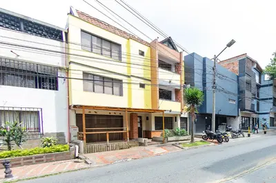 a yellow and white building on a city street at Hotel Medallo City in Medellín
