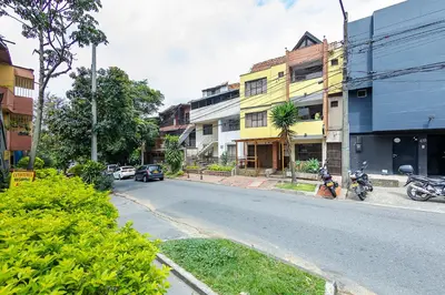 a street with motorcycles parked on the side of the road at Hotel Medallo City in Medellín