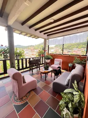 a living room with couches and chairs on a balcony at Loft Terraza Jericó in Jericó
