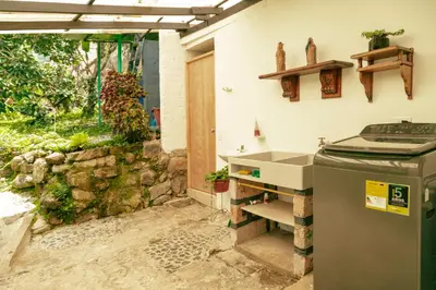 a kitchen with a sink and a stone wall at LUzArt in Jardin