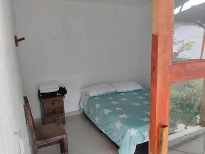 a small bedroom with a bunk bed and a chair at LUzArt in Jardin